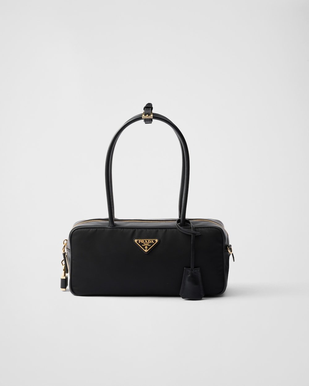 02f7e711fe364b2fa8968861c33fd728.jpg Re-Nylon and Leather Small Top-Handle Bag With Padlock - Image 1